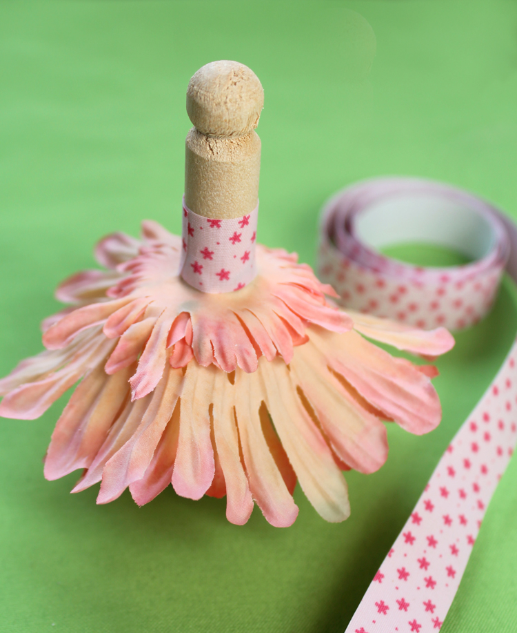 Wooden doll peg, silk flower petals and fabric tape