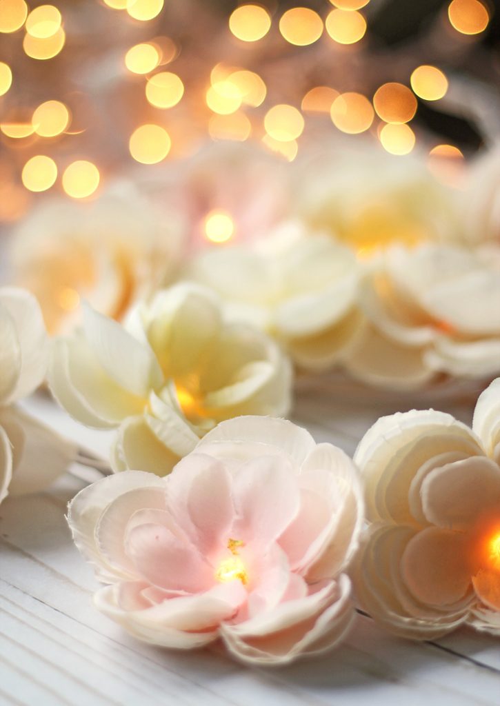 Learn to make a pretty garland using silk flowers and white Christmas lights.