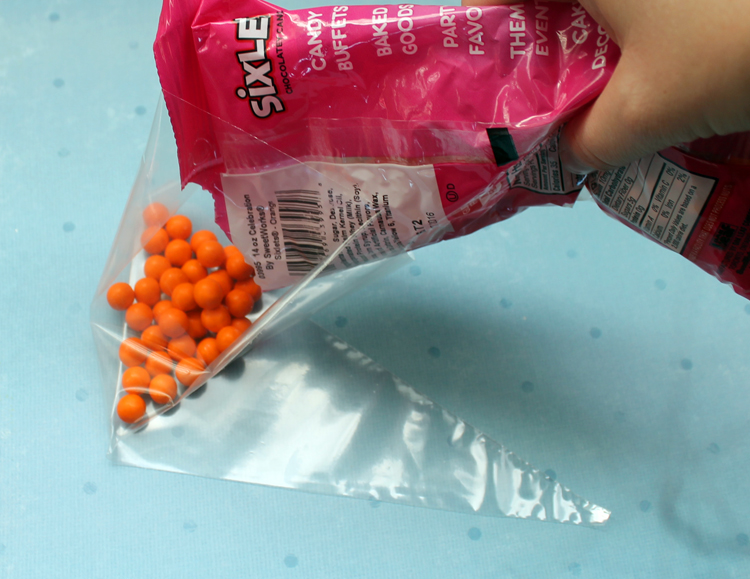 Package up Sixlets orange candies to look like a snowman nose!