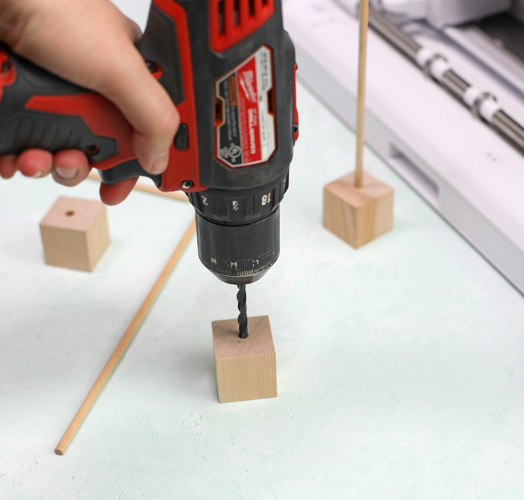 drill into wood base then insert dowel