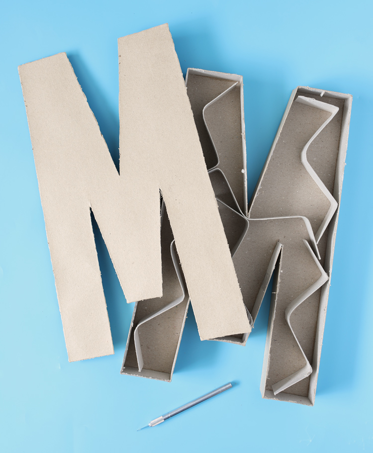 cutting apart paper mache letters