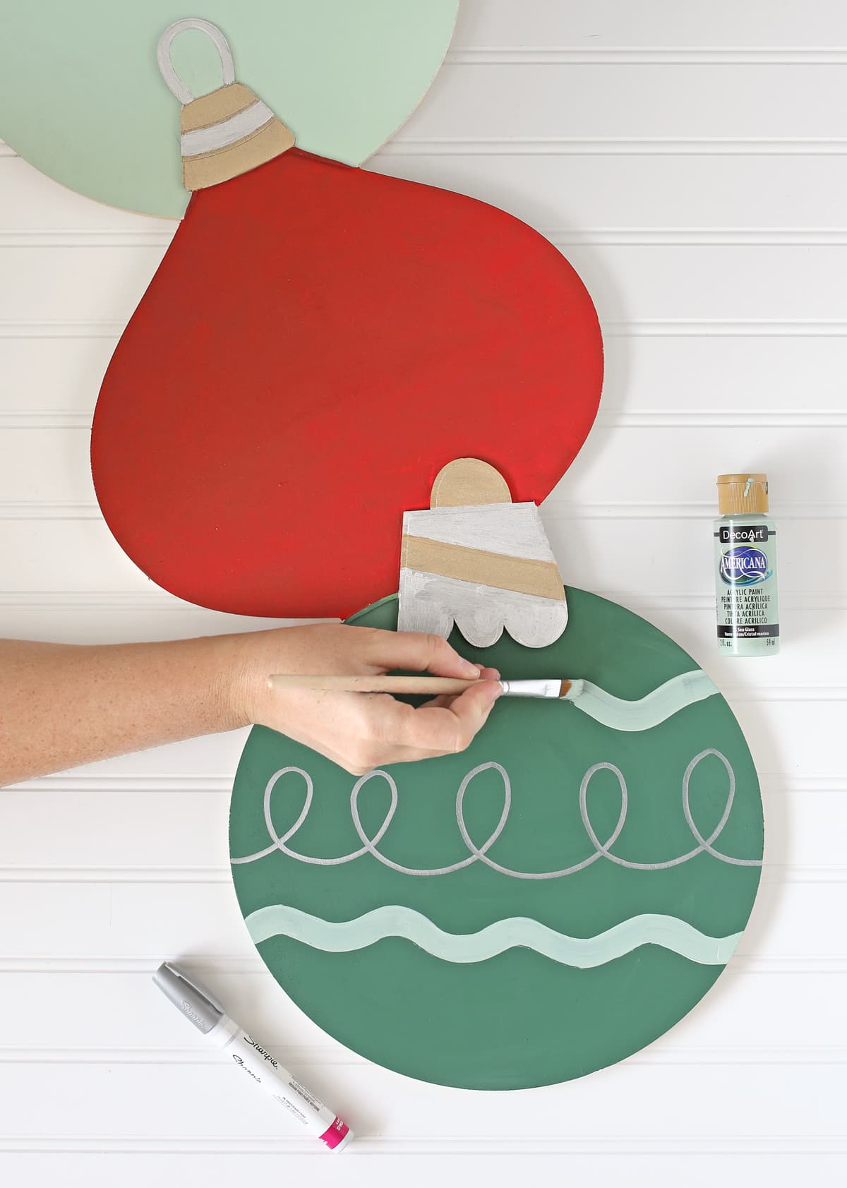 painting designs onto wood a christmas ornament decoration