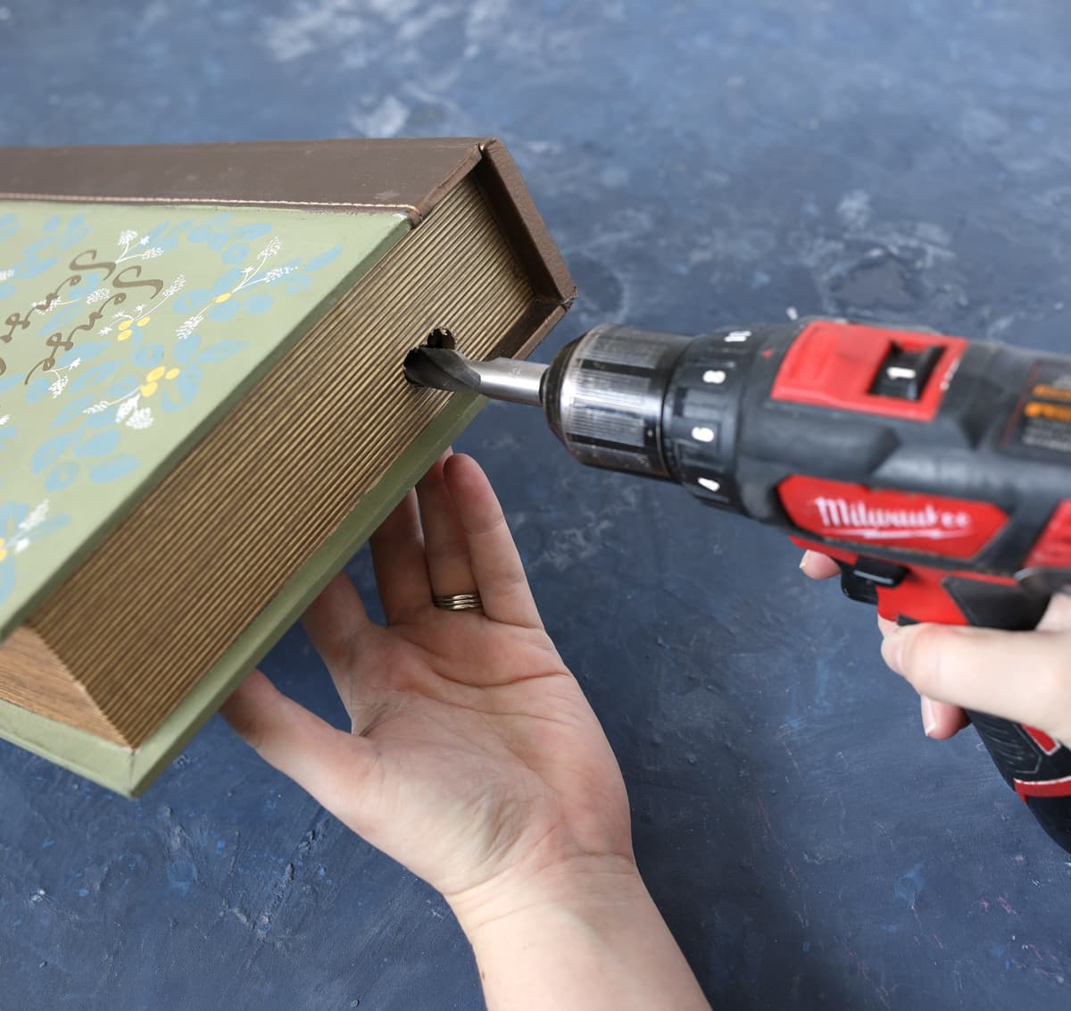 drilling a hole in a book box